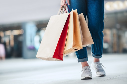 footfall Person with shopping bags walking on street.