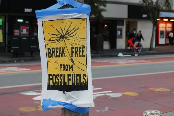 Sign on post reading 'Break free from fossil fuels'.