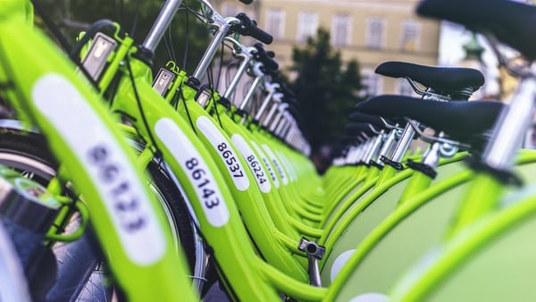 photo-1455641374154-422f32e234cd Rows of green bikes.