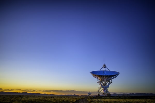 photo-1526666923127-b2970f64b422 Satellite dish in remote landscape.