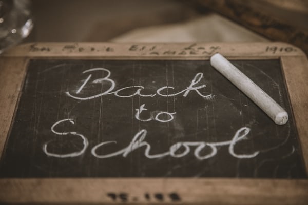 Blackboard reading 'Back to School' in cursive handwriting.