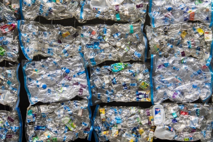 photo-1591193686104-fddba4d0e4d8 Cubes of plastic bottles/cartons compressed together as blocks.