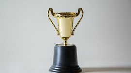 Image of small trophy against white background.