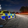 Wiltshire police car on dark lane in twilight